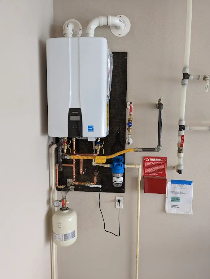 Professional plumber installing copper piping in a Meridian home